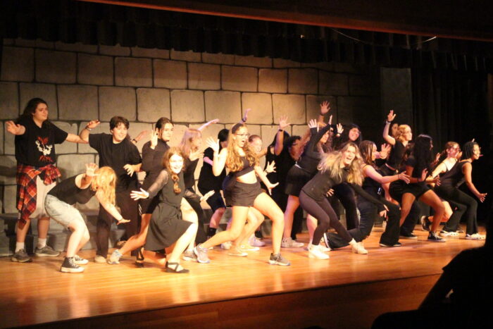 Students rehearsing on stage